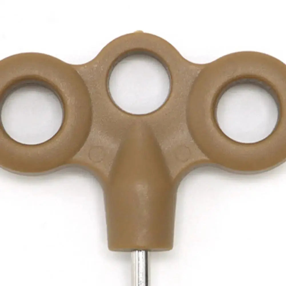 Brown plastic ground nail with three eye holes and a metal spike for outdoor rope fixing