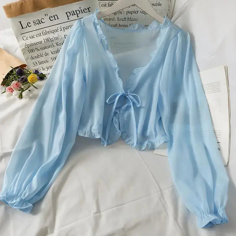 Light blue long-sleeve sheer blouse with tie-front bow and ruffled hem