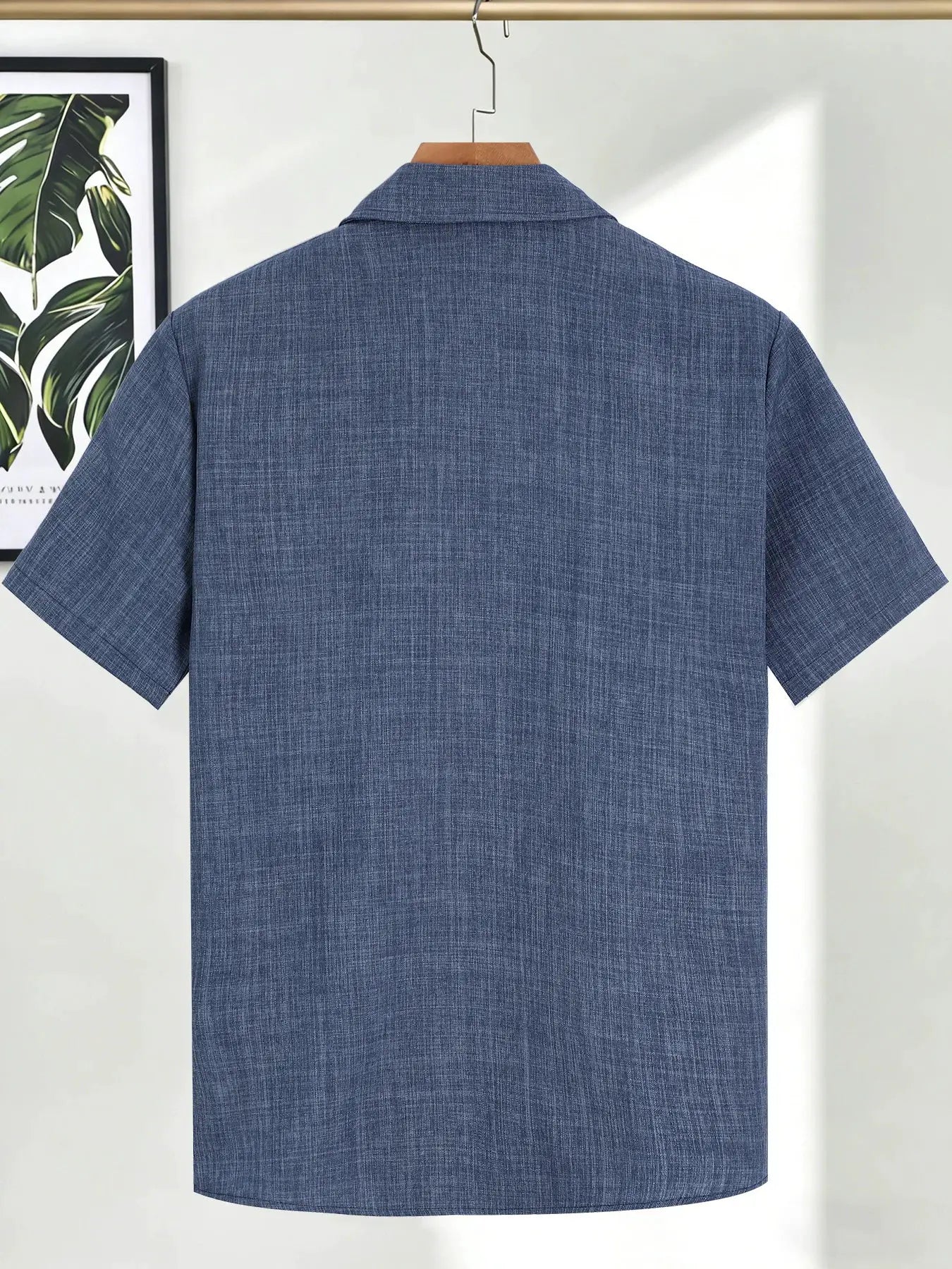 Men's blue linen short-sleeve shirt on hanger, textured fabric visible