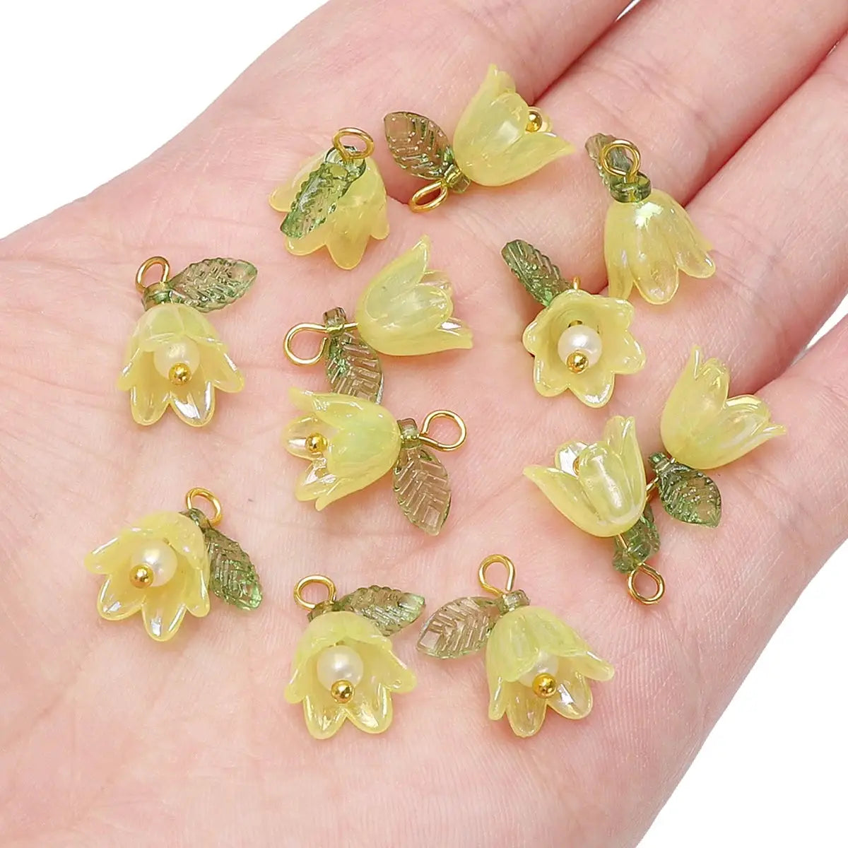 Acrylic lily-of-the-valley flower beads in pale yellow with green leaves and loops, 11x14mm, 2–10 pcs