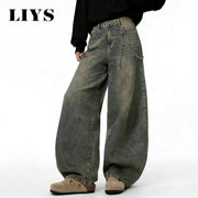 LIYS baggy wide-leg distressed denim jeans in washed gray with a silver chain accessory