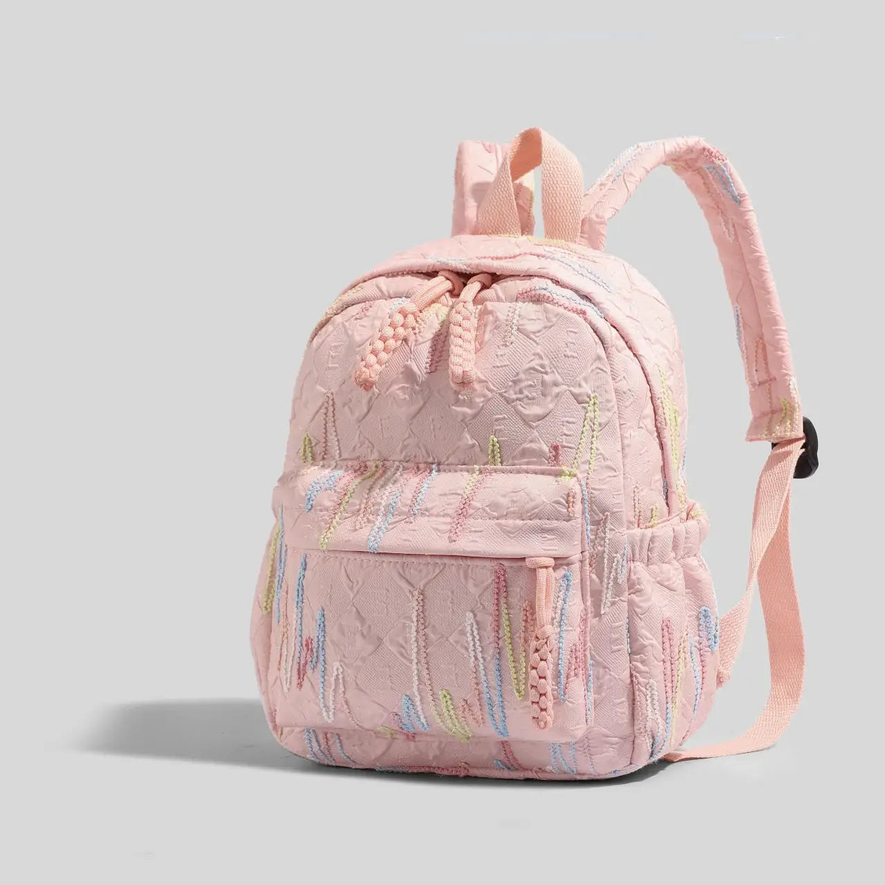 Women's pink quilted mini backpack by Simples Market with pastel embroidery and adjustable straps, zipper closure.