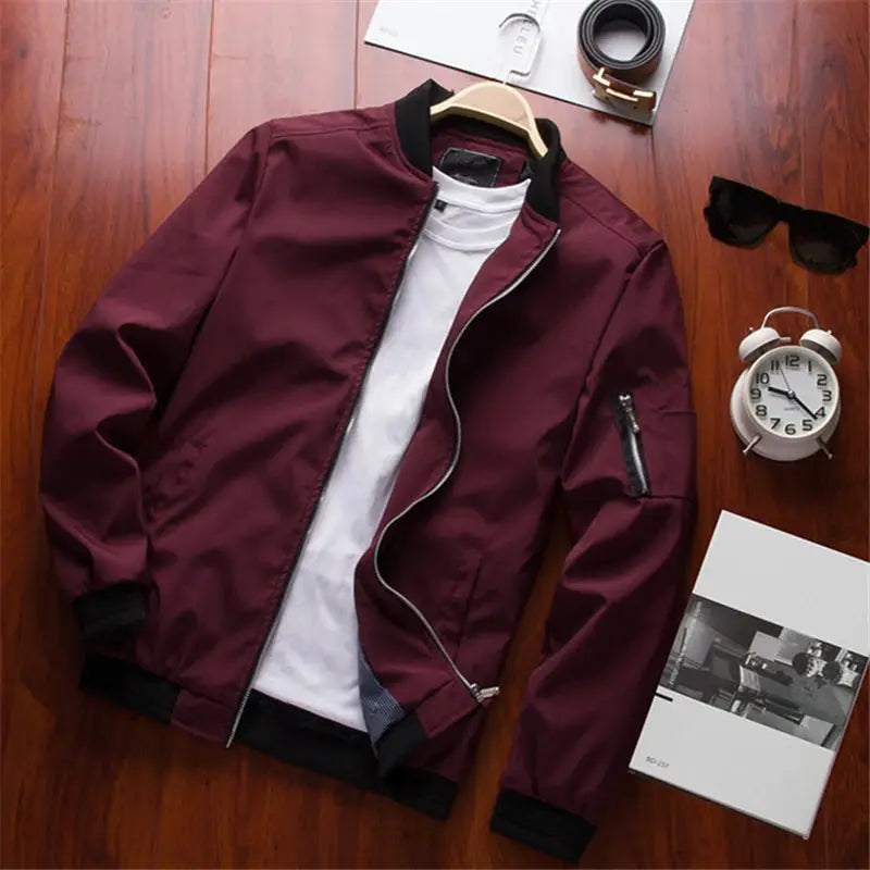 Men's burgundy bomber jacket by Simples Market with black rib cuffs and zip front, displayed with a white tee.