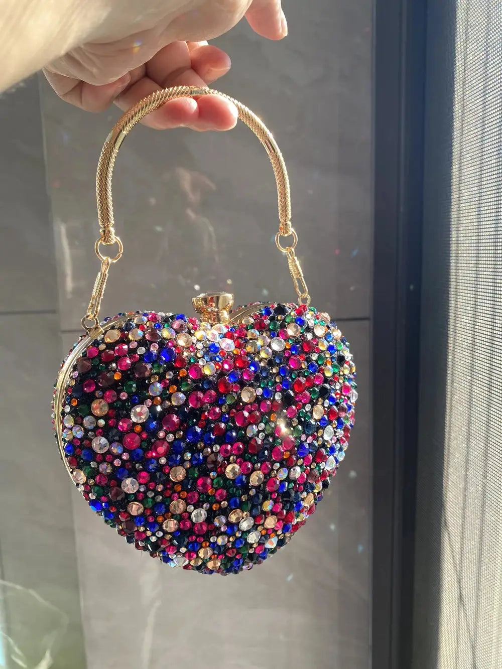 Simples Market heart-shaped crystal clutch purse encrusted with multicolor rhinestones and a gold-tone handle