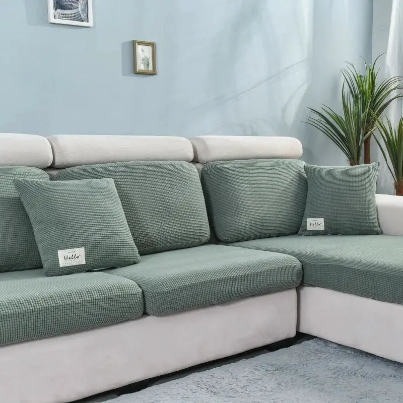 Simples Market thick elastic sofa cover in sage green on a sectional with textured cushions