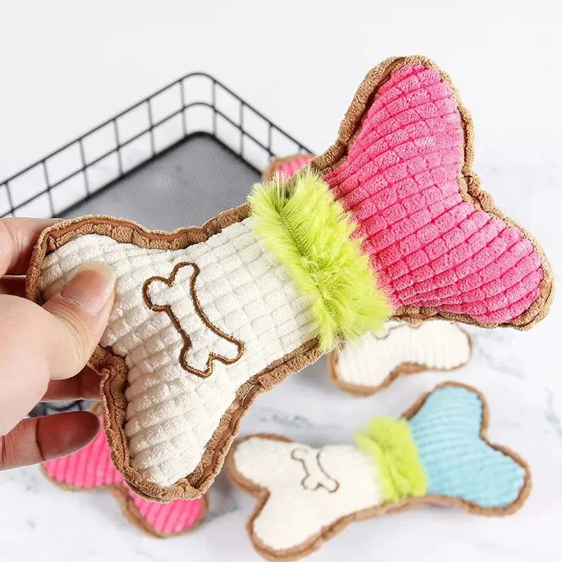Plush bone dog toy for small to medium breeds; white bone with brown trim and neon-green fur collar, pink and blue variants