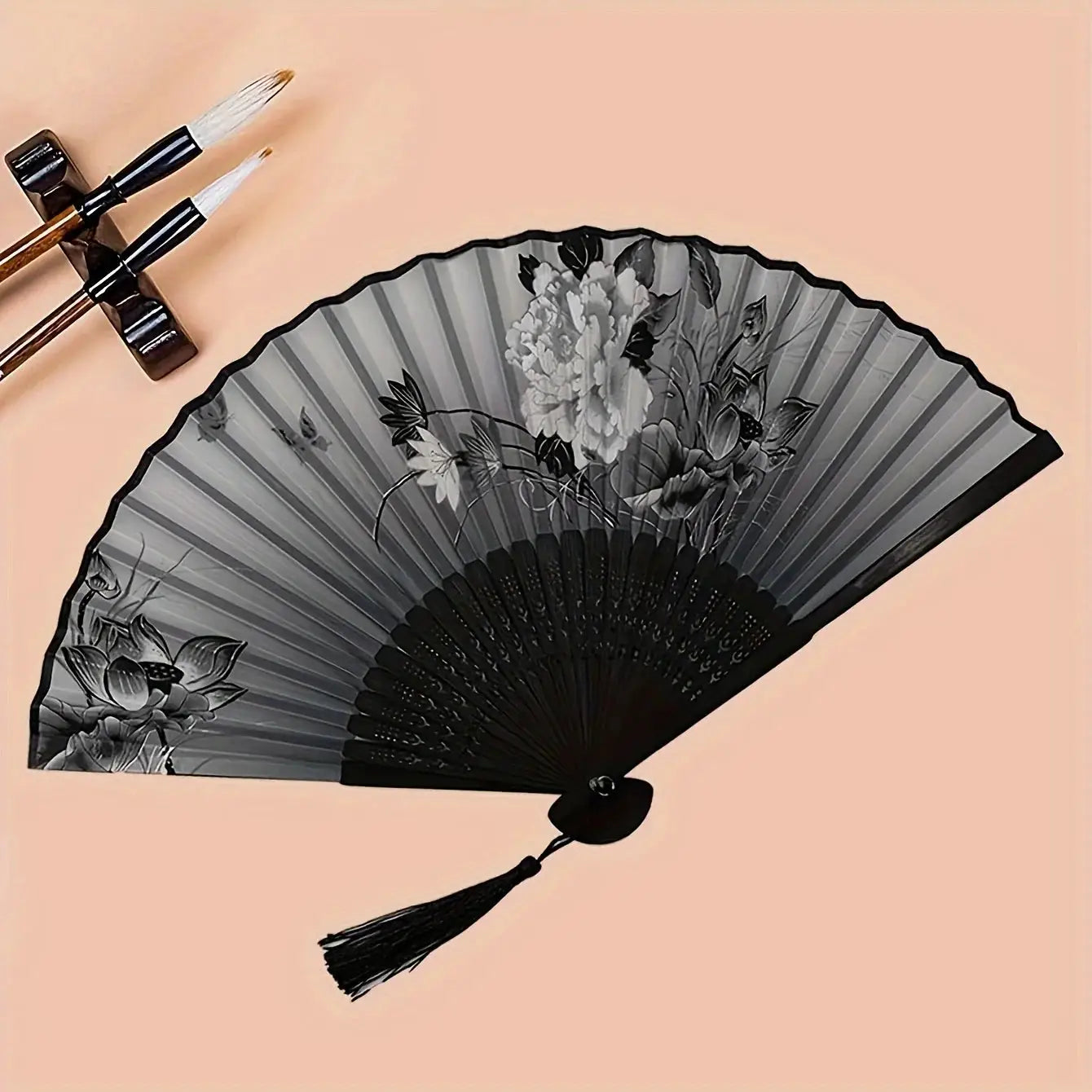 Bamboo hand folding fan with grayscale floral print and black tassel