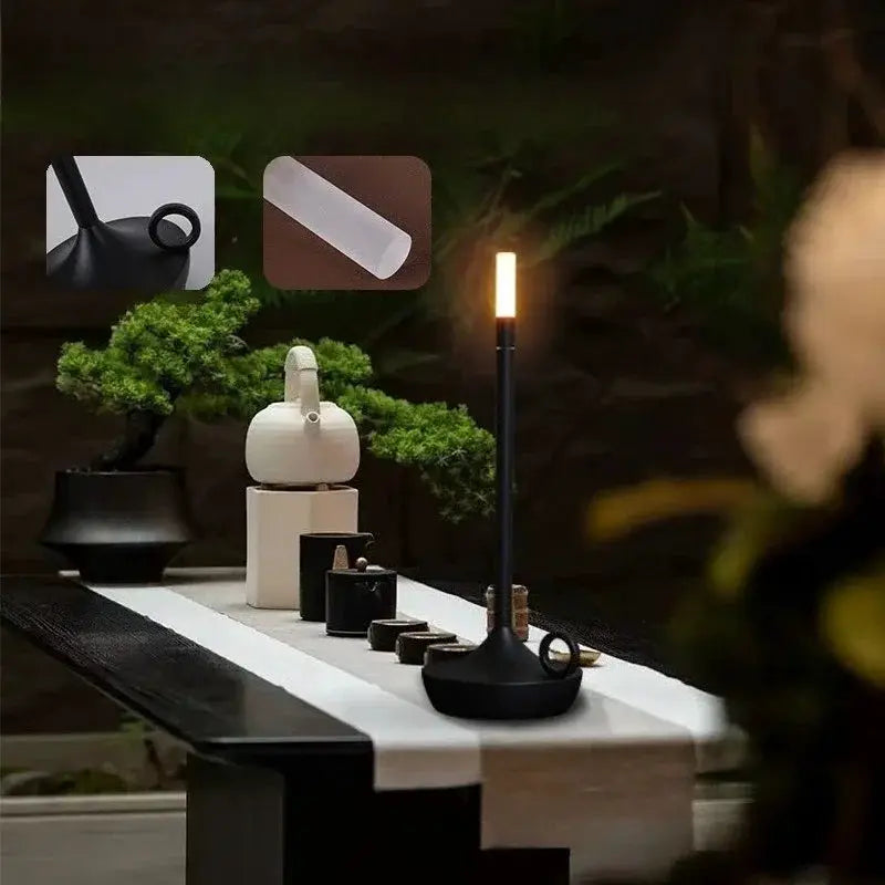 Atmosphere LED candle lamp; black base, USB-charging, touch-activated warm light for desktop decor.