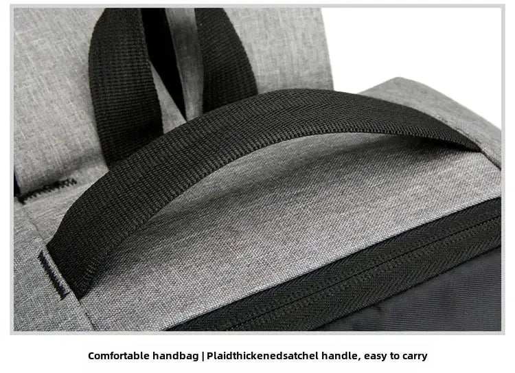 Travel smart laptop backpack by Simples Market with a thick black handle on gray shell fabric