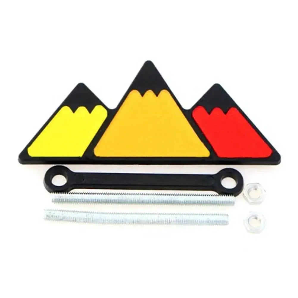 Grille badge emblem for Toyota by Simples Market with a three-color mountain logo and mounting hardware