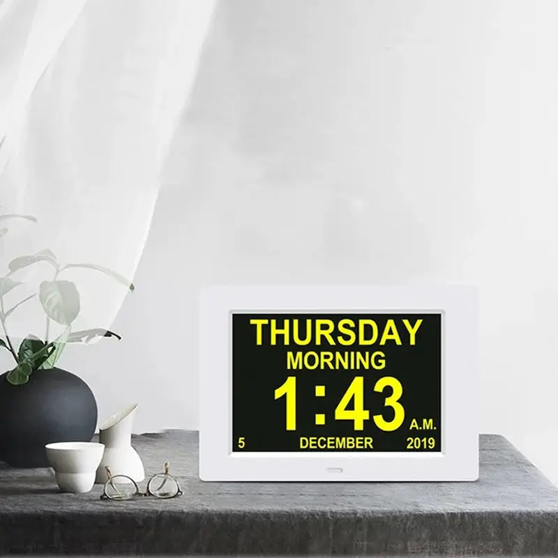 White LED calendar clock with large yellow digits displaying Thursday morning 1:43 AM