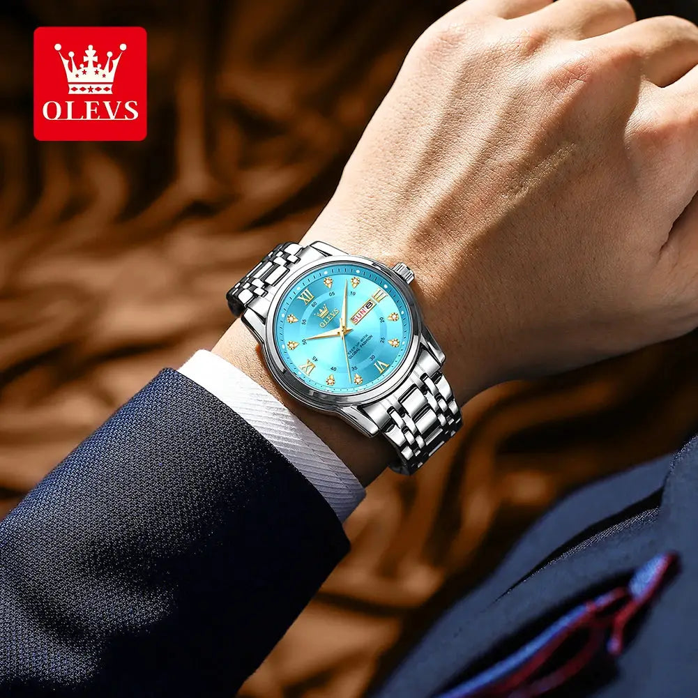 OLEVS men's quartz wristwatch with blue dial, diamond Roman markers, dual calendar and stainless steel bracelet