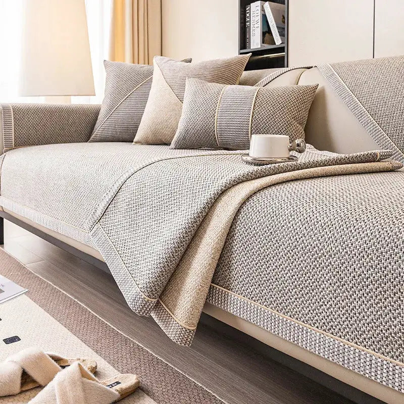 Linen sofa cushion set in beige woven fabric with matching throw on a neutral sofa