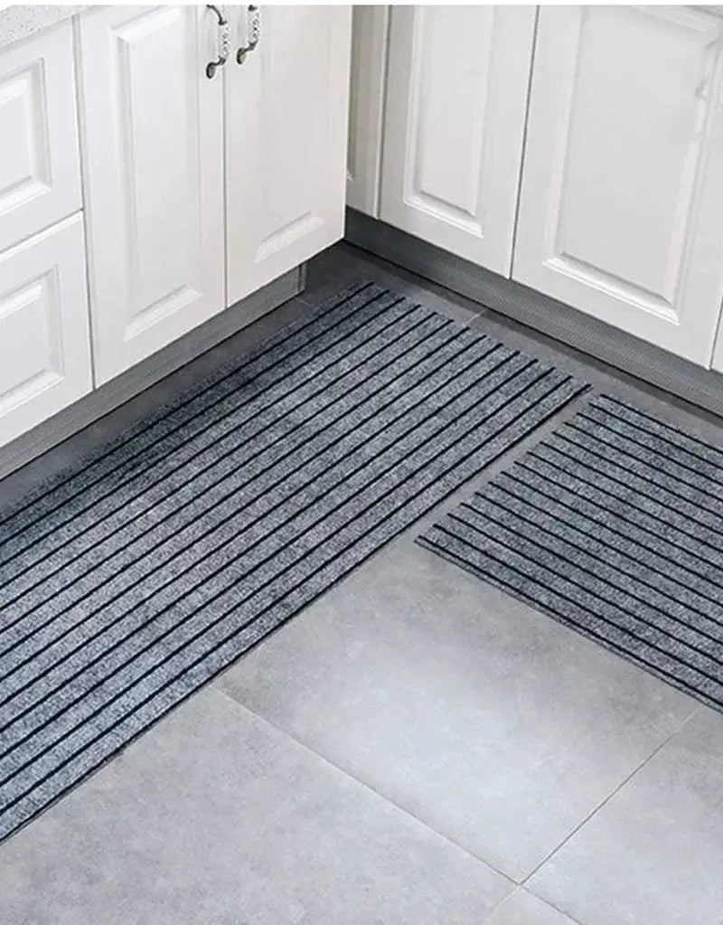 Two dark gray striped entrance mats; anti-slip, water and oil absorbent for indoor/outdoor use.