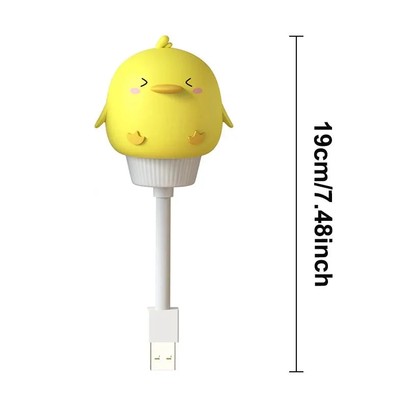 USB night light with yellow chick cartoon head on white base, by Simples Market, 19 cm tall.