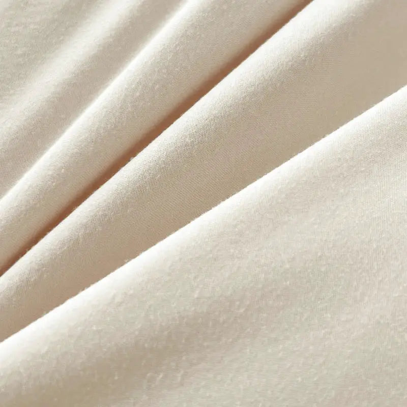 Beige brush fabric bed set closeup; solid color textile texture