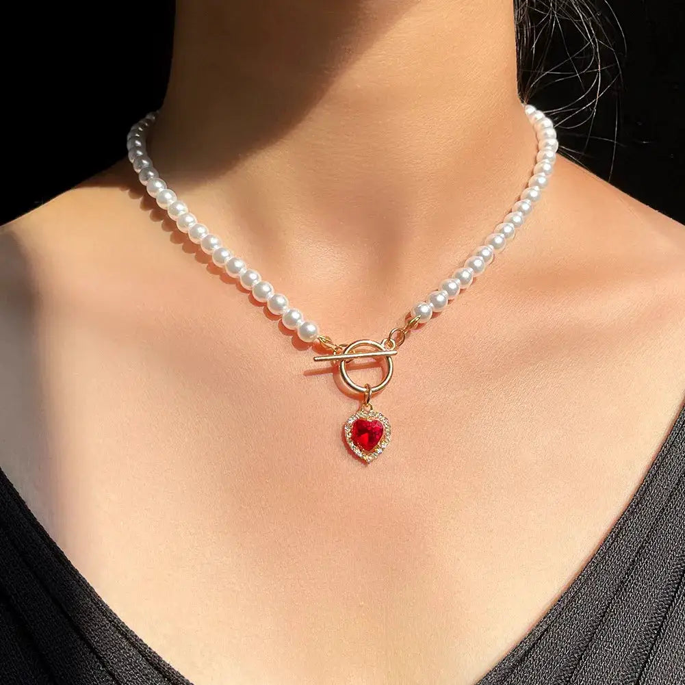 Pearl choker necklace with gold-tone toggle clasp and red crystal heart pendant