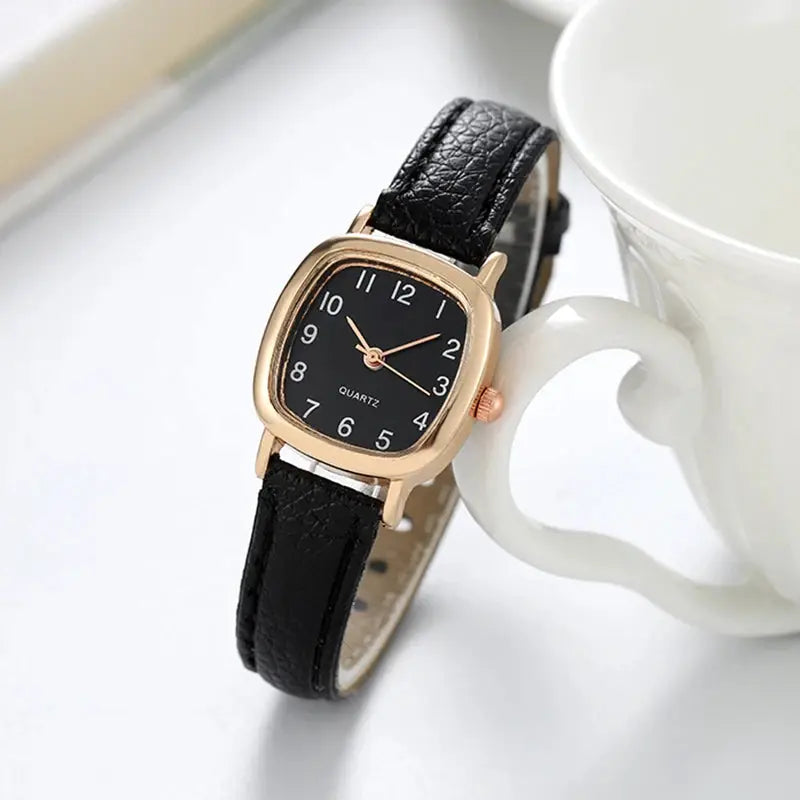 Women's Simples Market watch; black dial, rose-gold case, black leather strap, Arabic numerals, quartz