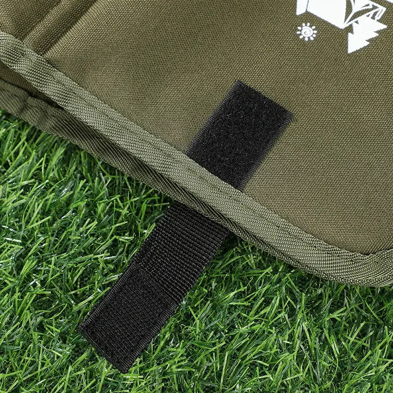 Outdoor camping foldable seat cushion moisture-proof mat in olive green with black Velcro strap on grass
