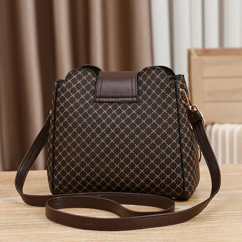 Brown check-print women's handbag with leather trim and long crossbody strap