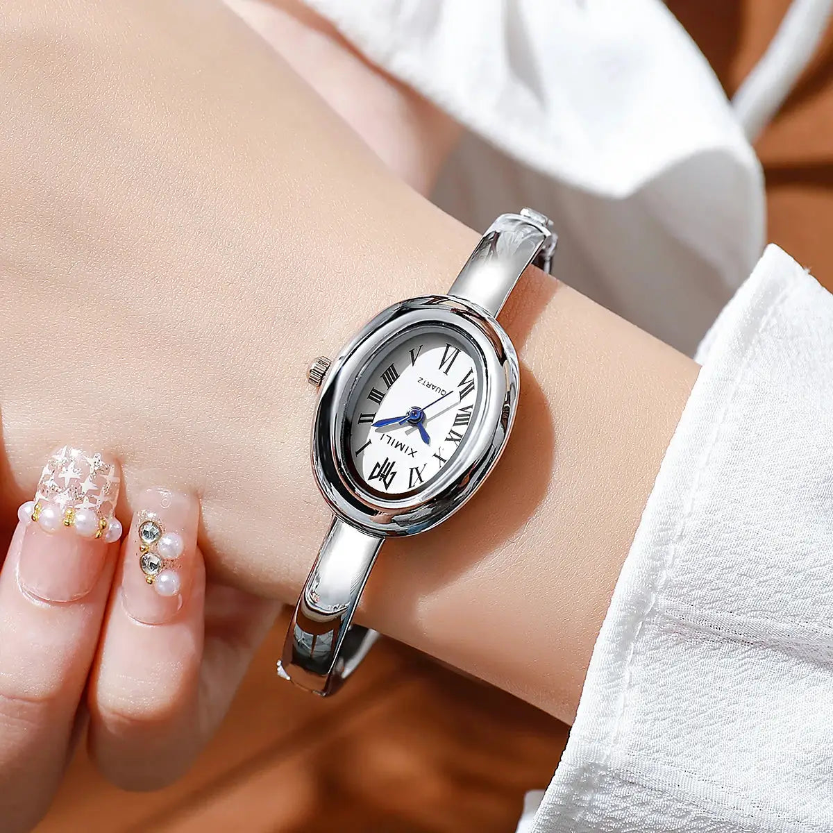 Women's luxury quartz wristwatch, silver stainless-steel band, oval white dial by Simples Market