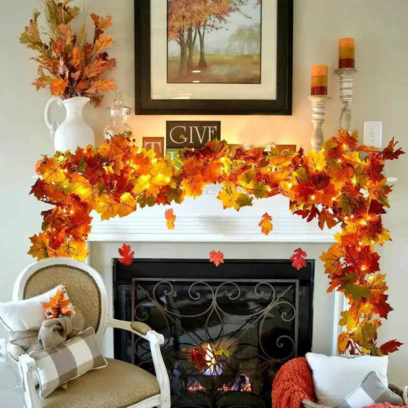 Autumn maple leaf wreath by Simples Market, 200cm, draped over a white fireplace mantle with orange-yellow leaves