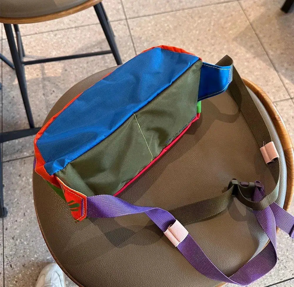 Waist bag; camel-toned body with blue/green panels and purple strap, large capacity