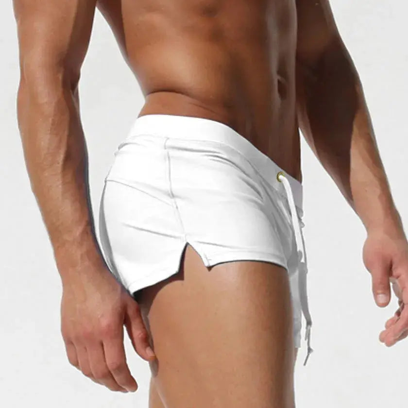 Men's white swim trunks with drawstring and curved hems