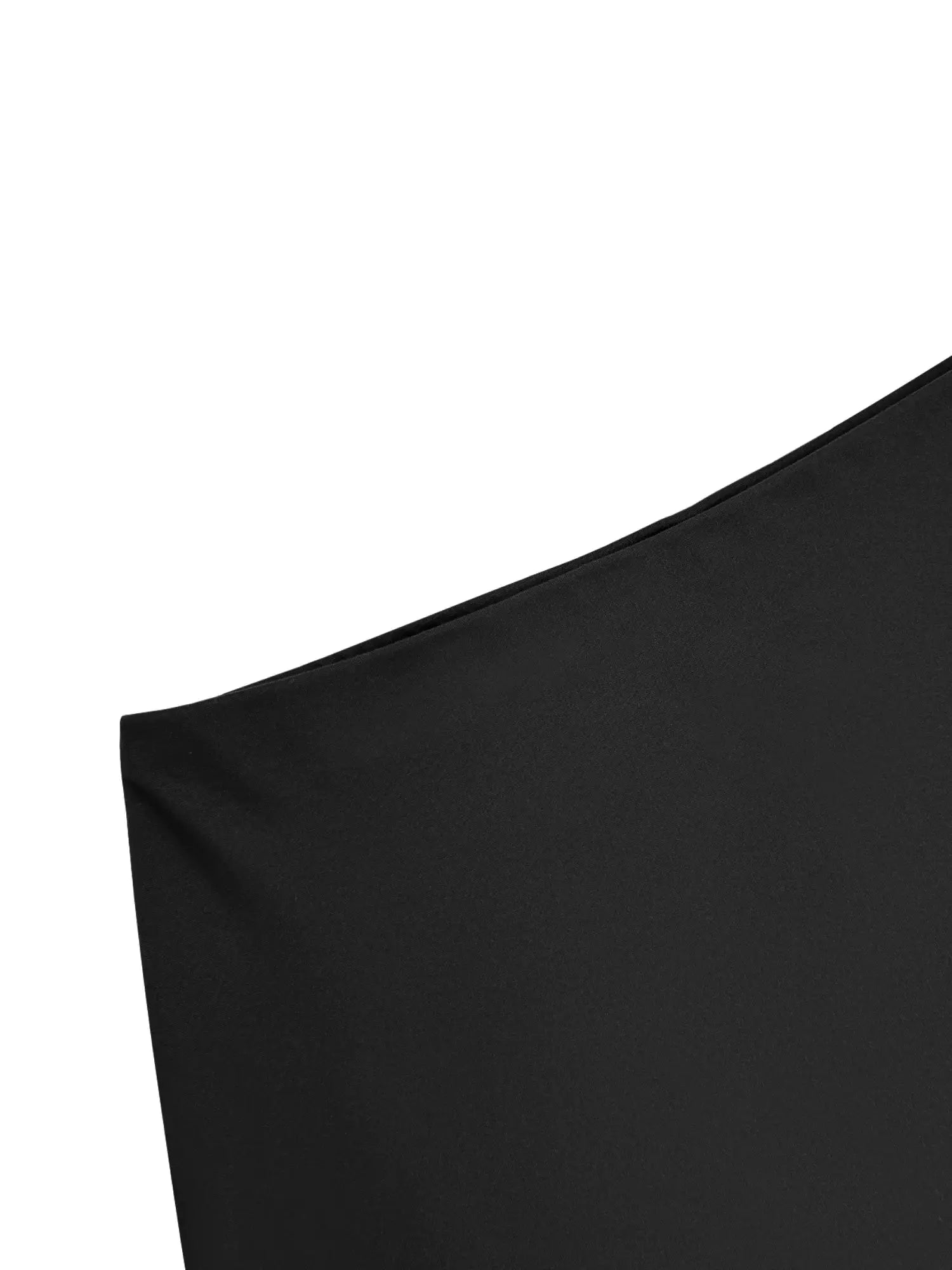 Skort in black solid color fabric close-up showing hem seam and smooth material.