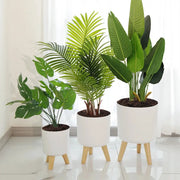 Floor-standing round white plant pots on natural wooden legs, set of 3.