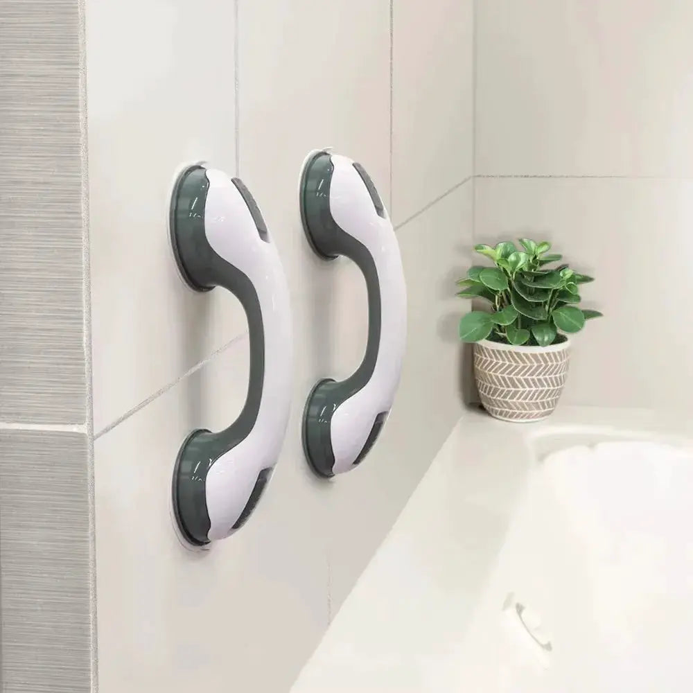 Pair of white and gray shower grab bars with dual locking suction cups mounted on a tiled bathroom wall beside a tub