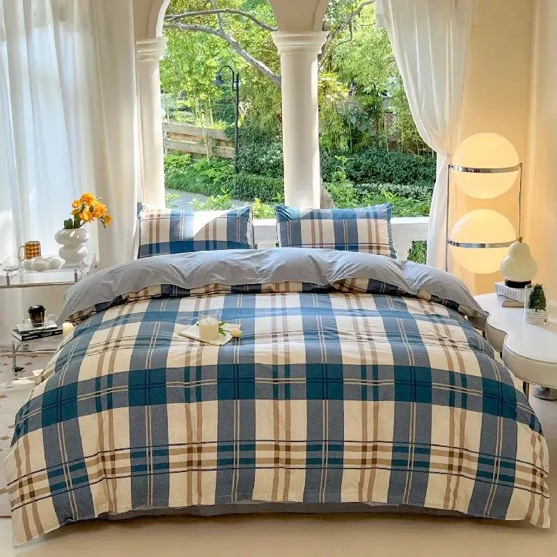Bed set with blue and beige plaid duvet cover and two matching pillowcases on the bed