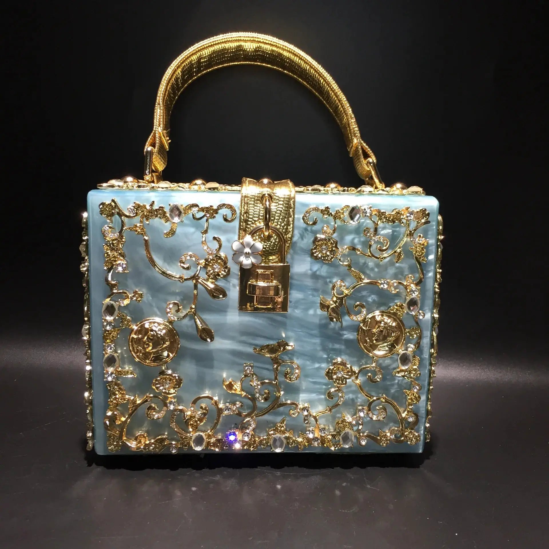 Evening bag blue crystal-embellished with gold floral filigree and ornate handle.