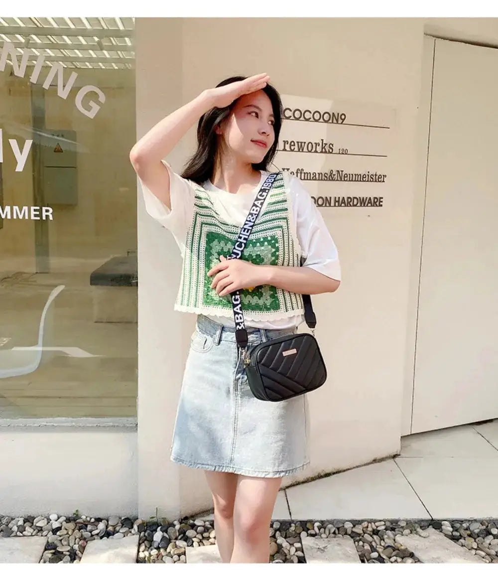Shoulder crossbody bag; small black quilted PU bag with a white-printed strap.