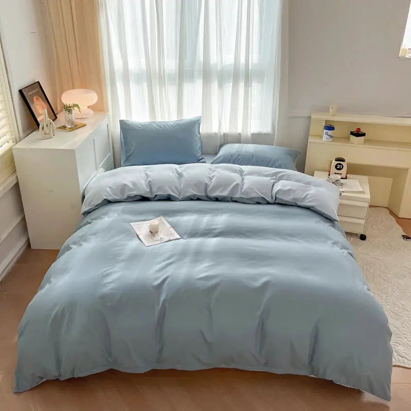 Light blue 4-piece brush-fabric bedding set with duvet cover and pillowcases on a bed