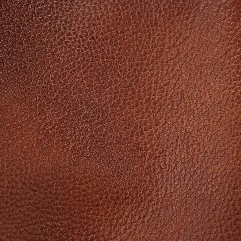Chest bag in brown genuine top-grain leather by Simples Market; close-up leather texture