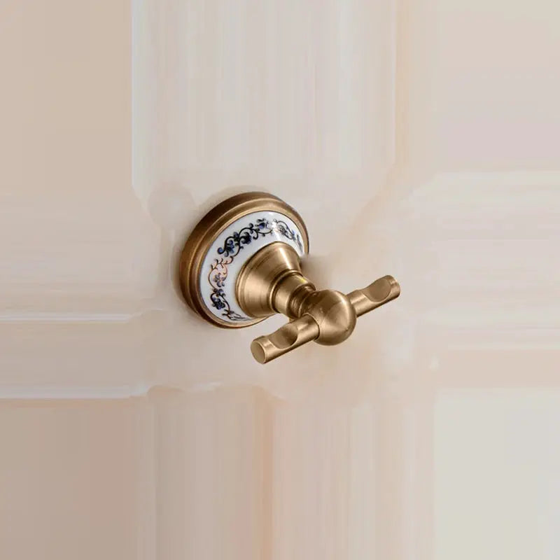 Antique brushed solid-brass bathroom hardware set with blue floral porcelain plate and cross-handle knob
