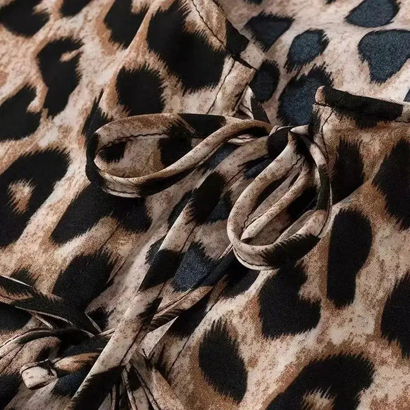 Leopard print wrap crop top with puff sleeves and tie detail
