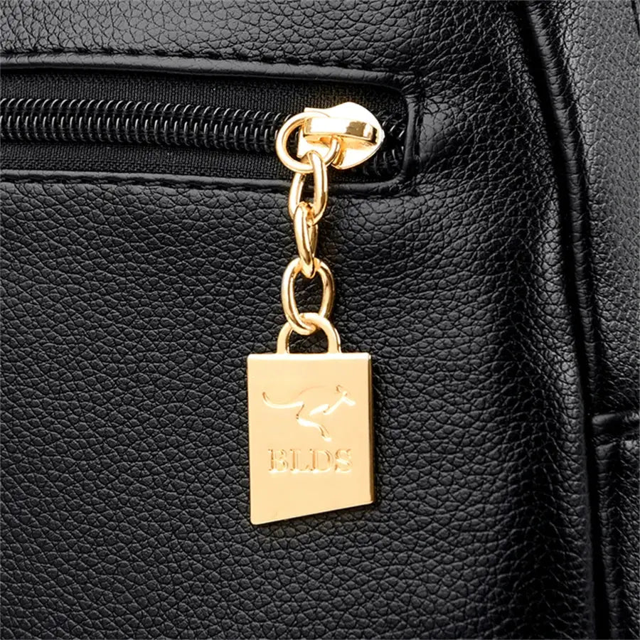 Black leather backpack with gold zipper and BLDS logo charm