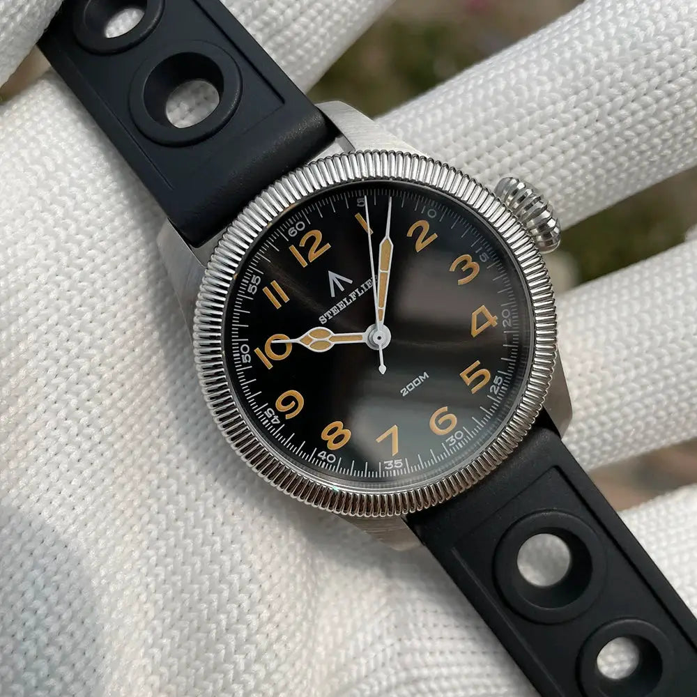 STEELFLIER SF741 quartz watch with black dial, orange numerals, silver bezel, and rubber strap
