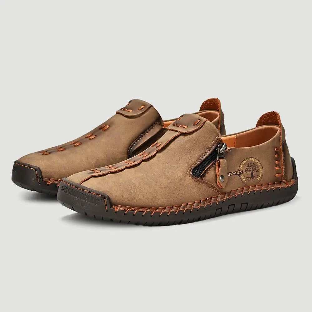 Pair of handmade leather men's casual loafers with side zip, brown breathable moccasins