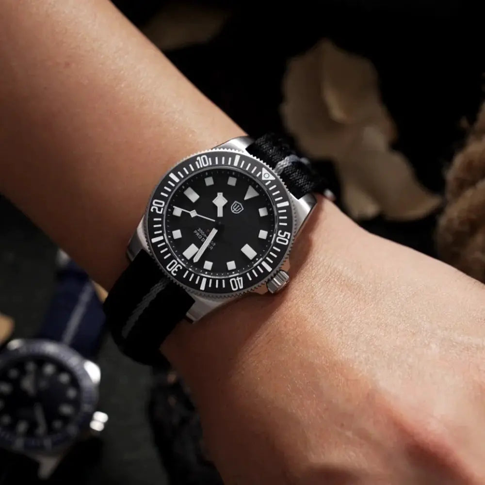 Watchdives EXD 40mm dive watch on wrist; black dial luminous markers, rotating bezel, stainless steel case, nylon strap.