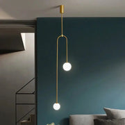 Modern glass ball pendant light in gold with double LED globes for living room or hallway.