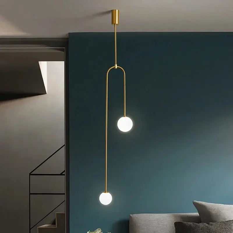 Modern glass ball pendant light in gold with double LED globes for living room or hallway.