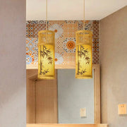 Two natural bamboo lantern chandeliers with slatted panels and warm yellow glow
