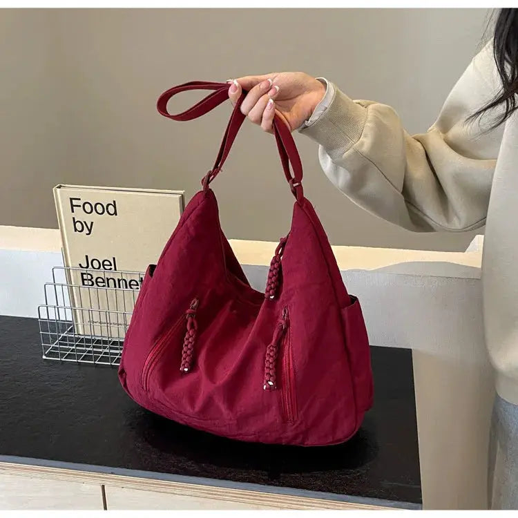Simples Market women's burgundy soft-cloth shoulder bag with braided zipper pulls and dual handles