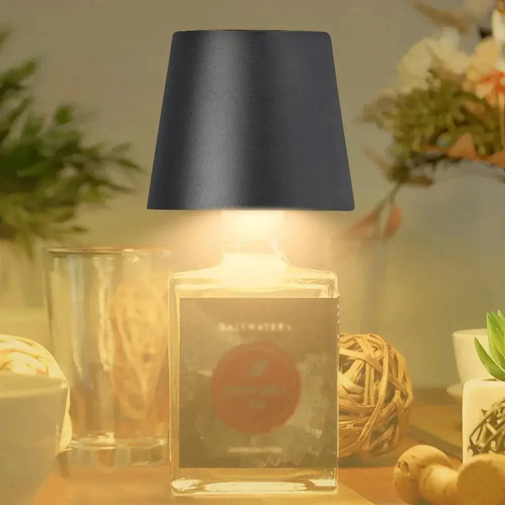 Wireless LED bottle lamp with black lampshade atop a clear glass bottle base