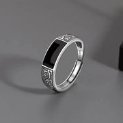 Sterling silver men's ring with black inlay and ornate engraved side panels