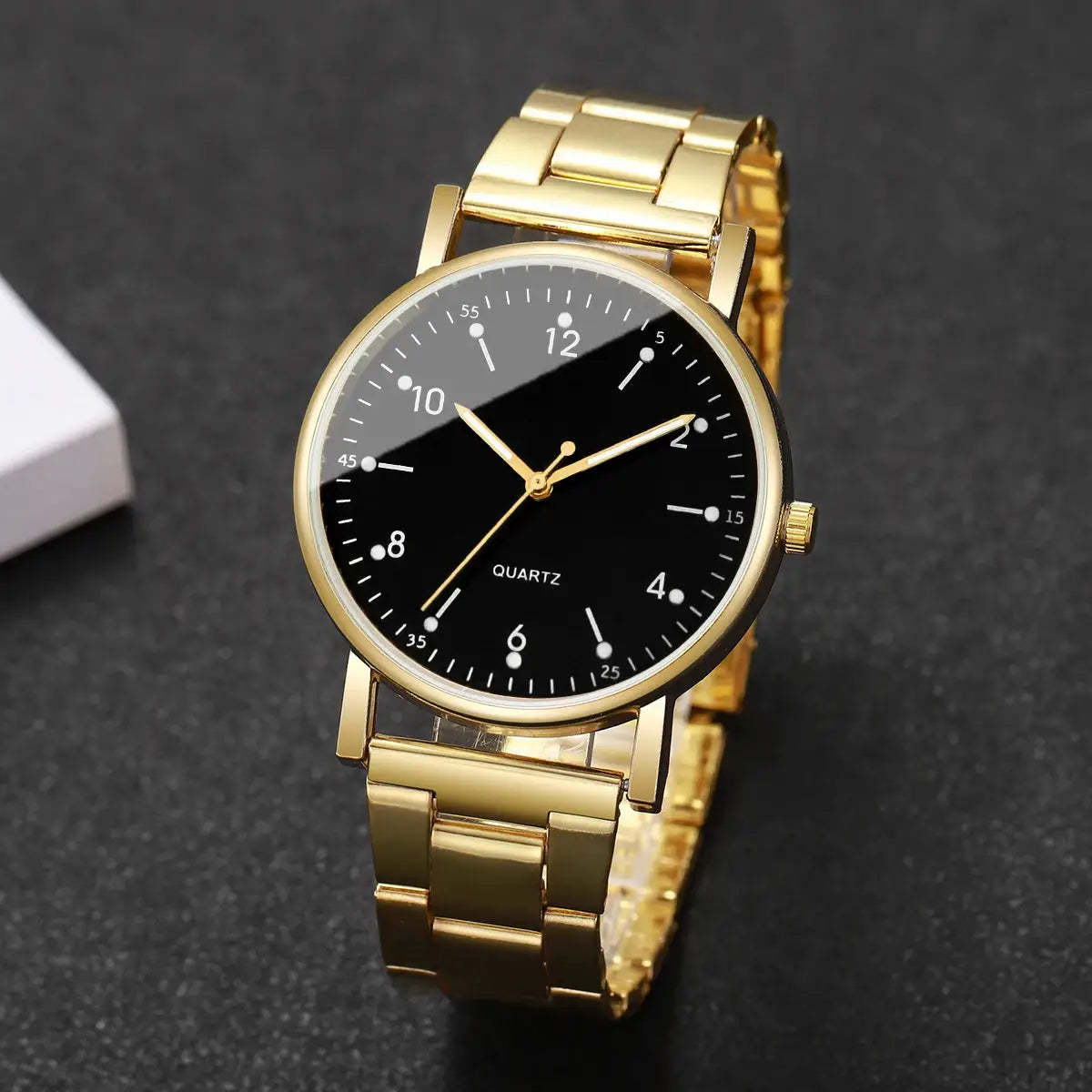 Gold-tone women's quartz wristwatch with black dial and metal bracelet