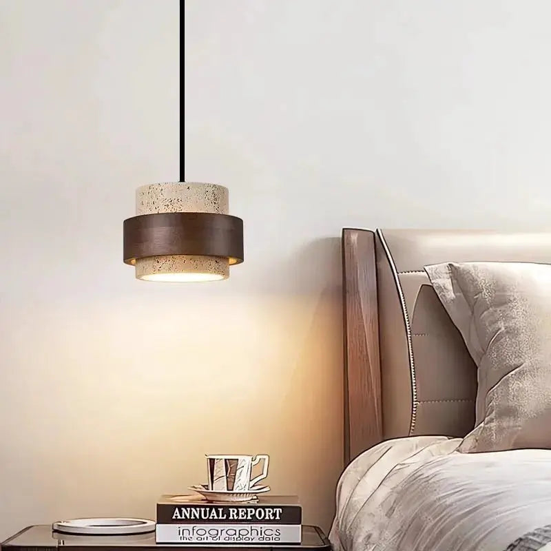 Japanese Wabi Sabi style pendant lamp with stacked beige speckled top, dark brown middle band hung over a bed.